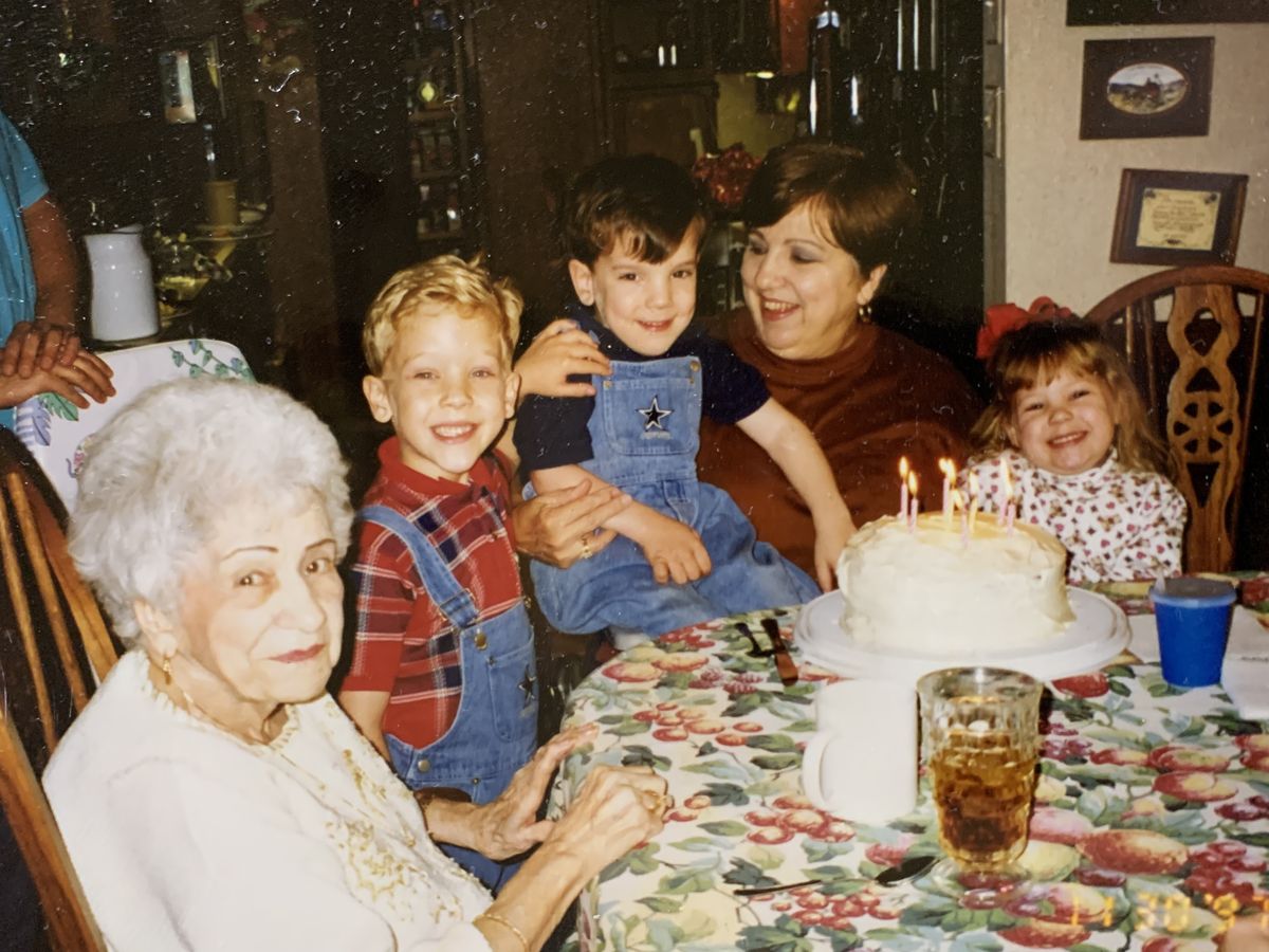 A family celebrating a birthday together around a table
